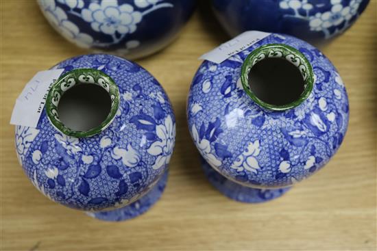 Three Oriental blue and white jars and covers, and a pair of vases